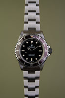 1997 Rolex 14060 Submariner with Tropical bezel