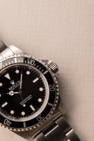 1997 Rolex 14060 Submariner - Box & Paper